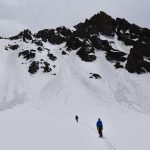 A picture of Jeremiah Meizis' two clients, Jasper and Nnamdi, learning the basics of moving on a rope team before heading up the Zig-Zag couloir in front of them on Handies Peak in the Handies Peak Wilderness of Colo.