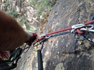 A pre-rigged rappel, one of the common ways of rappelling with clients. The guide can set up and safety check the system before descending to the next anchor, and then provide a fireman’s backup from there.