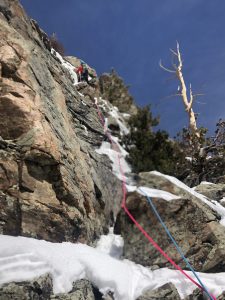 aki-leading-up-a-mixed-up-pitch-on-east-glacier-knob-in-rmnp
